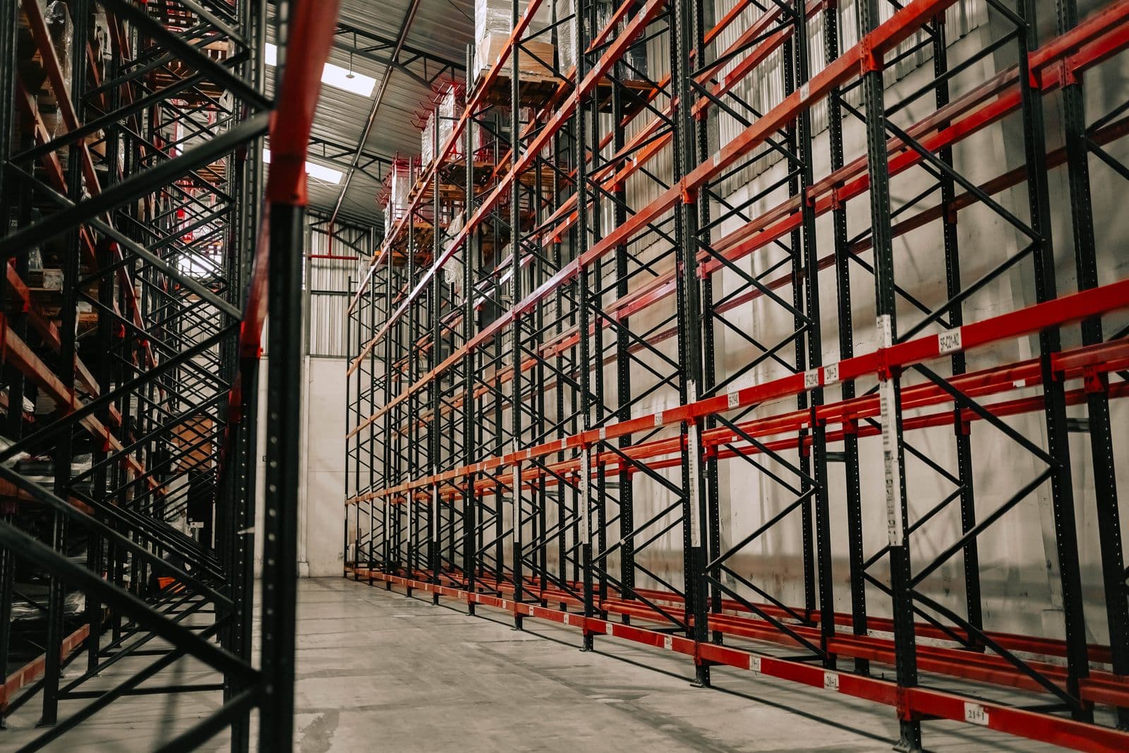 Large commercial warehouse interior with tall pallet racks